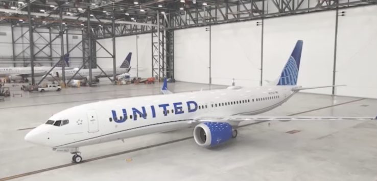 a white airplane in a hangar