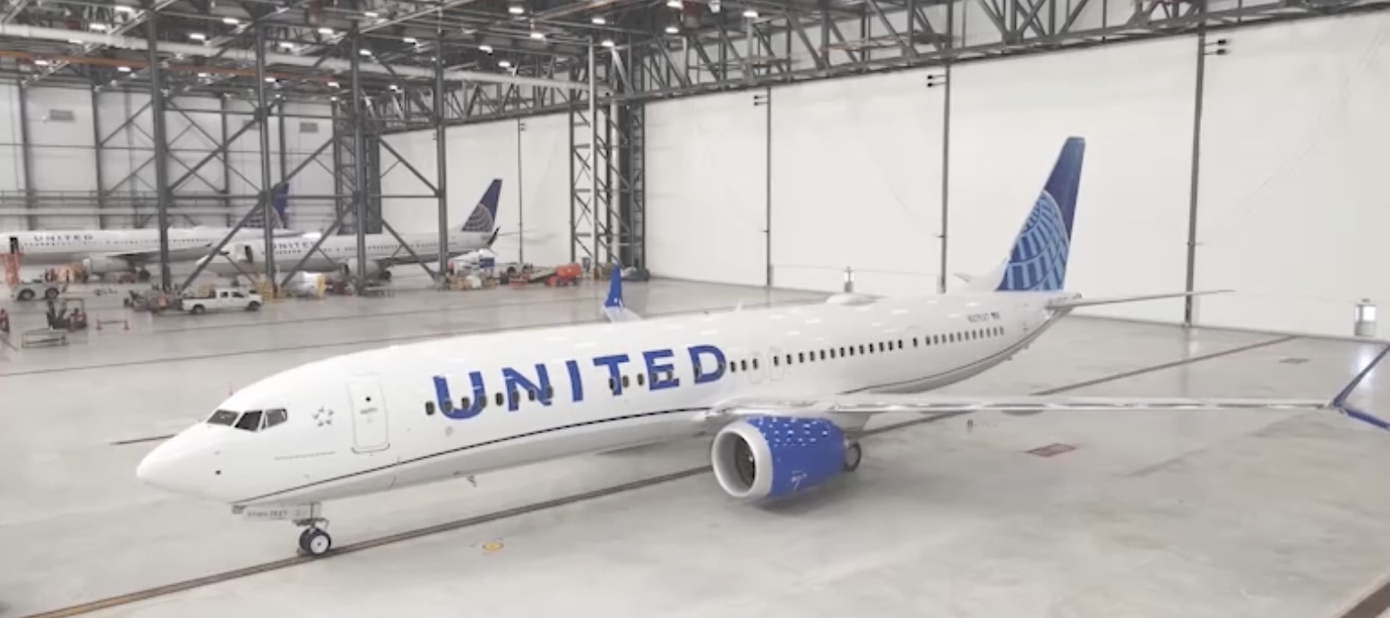 a white airplane in a hangar