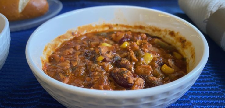 a bowl of chili with corn and beans