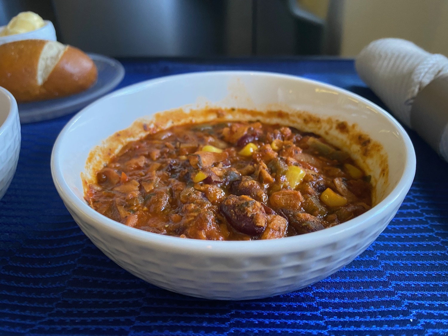a bowl of chili with corn and beans