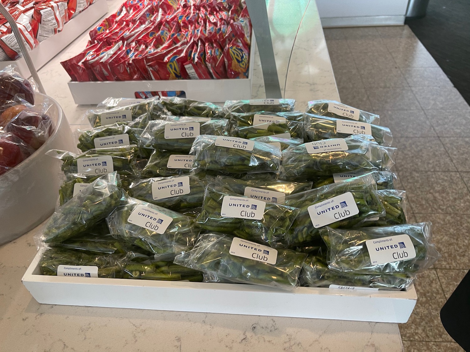 a box of green beans in plastic bags