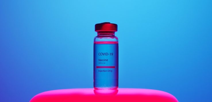 a vial of liquid with a red lid