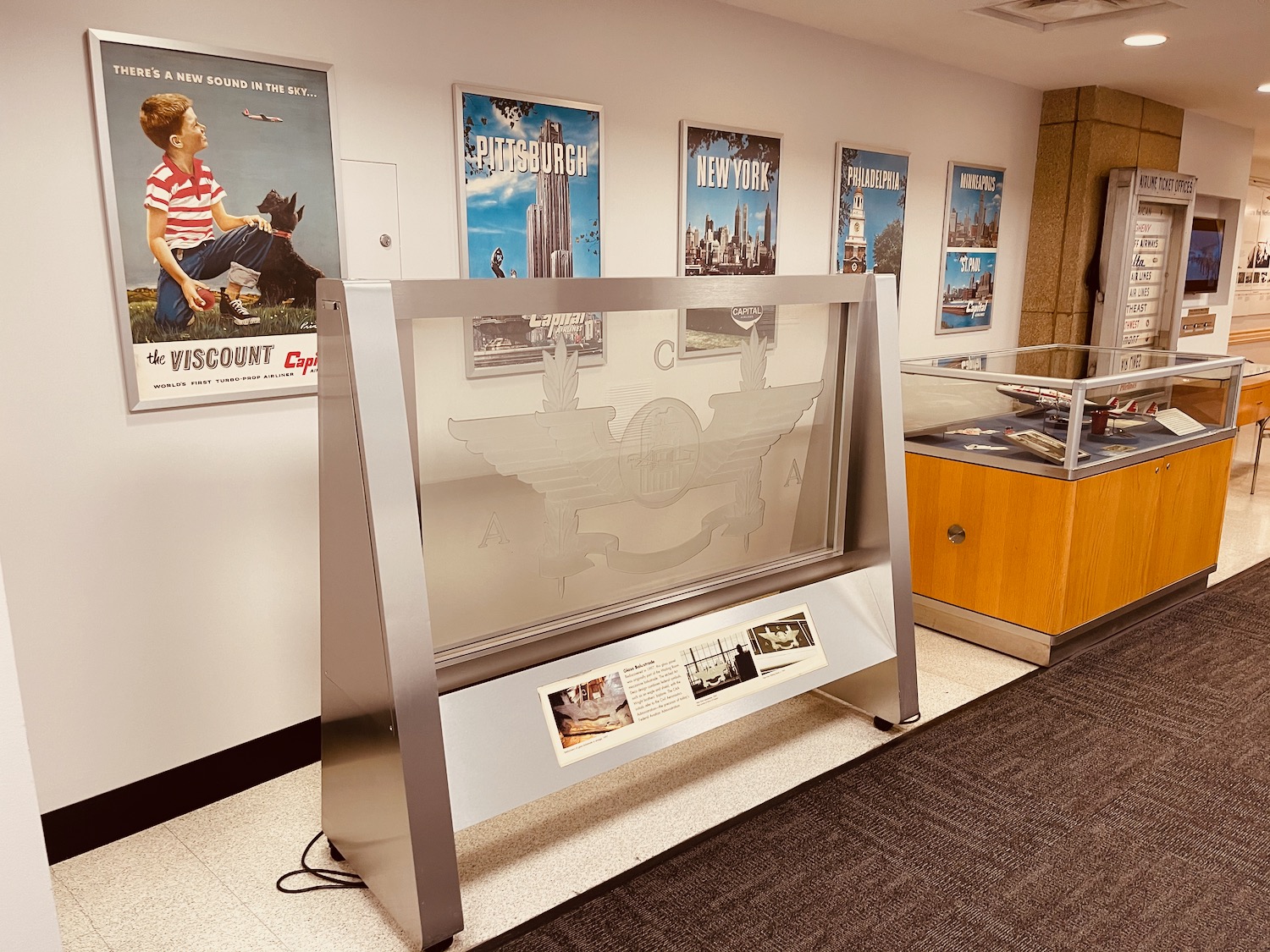 a display case with a glass display case and a display case with a picture of a plane