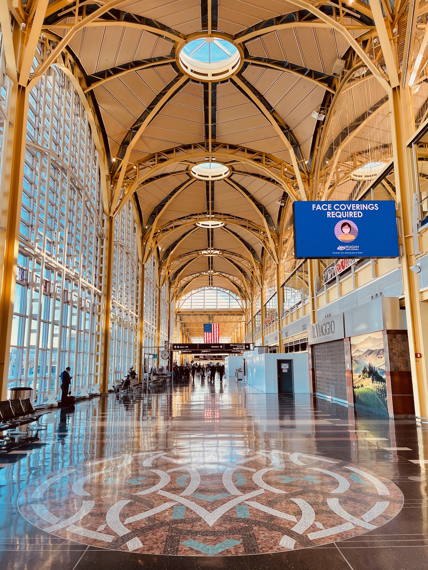 a large building with a tiled floor and a blue sign