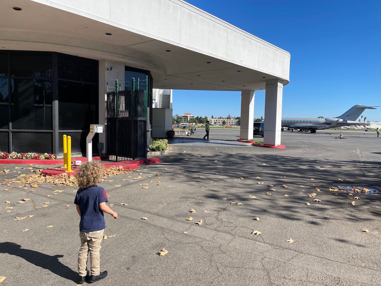 a child standing in front of a building