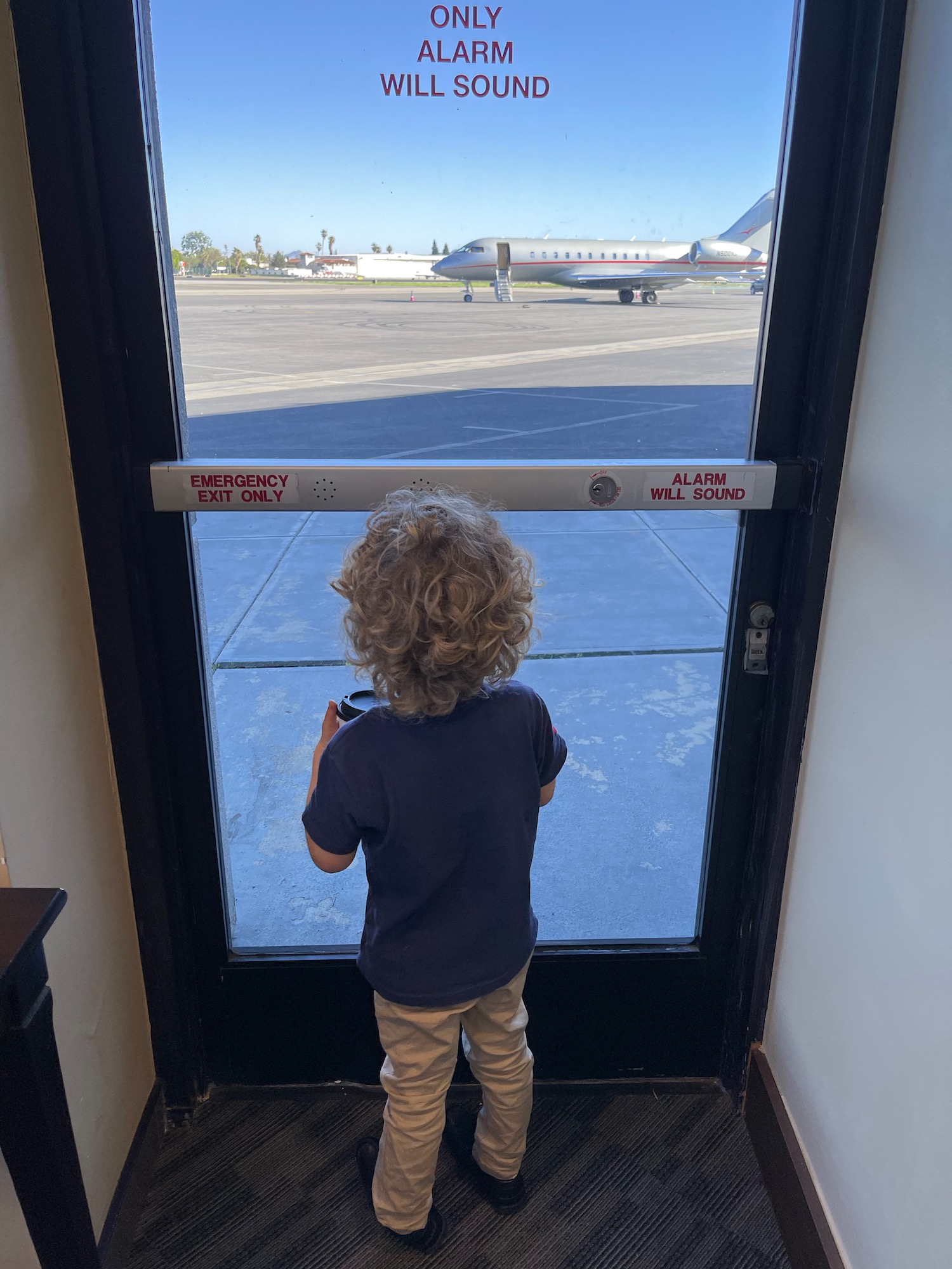 a child looking at an airplane
