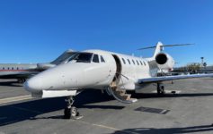 a white airplane with open door