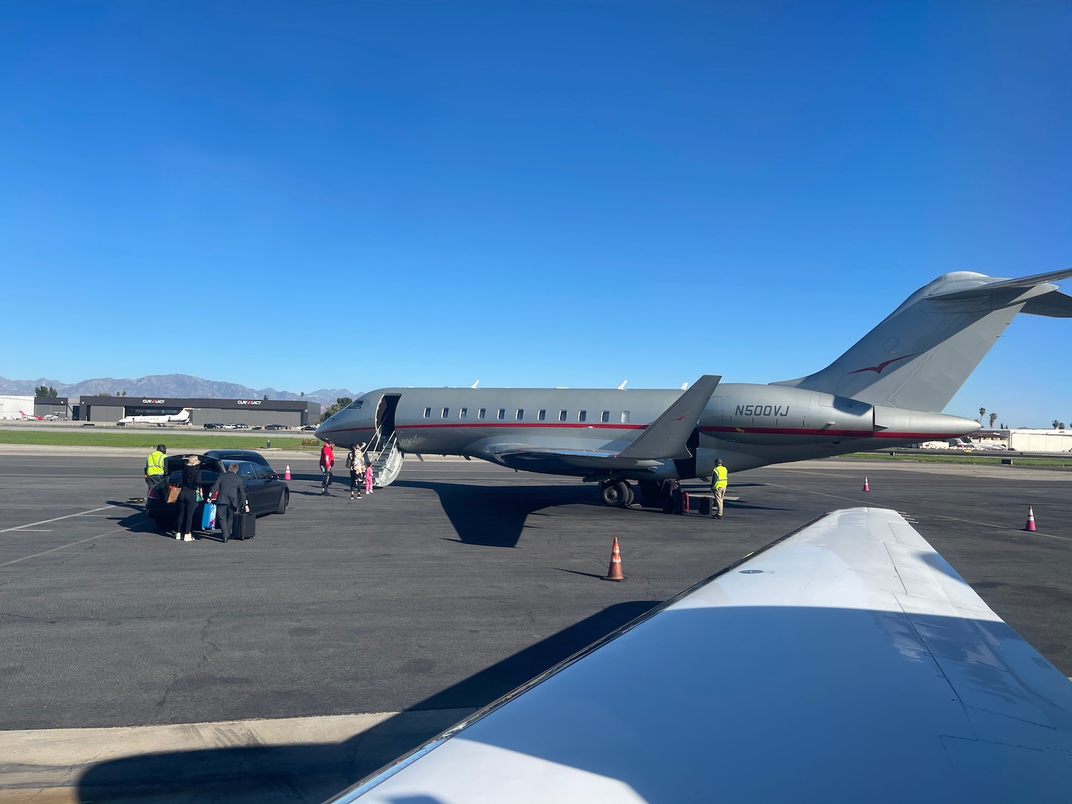 a group of people standing next to a plane