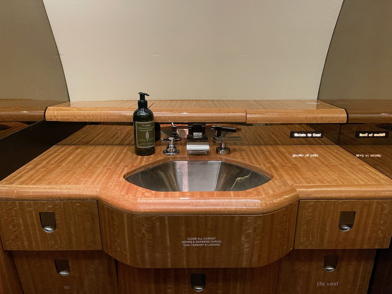 a sink with a bottle of liquid on it