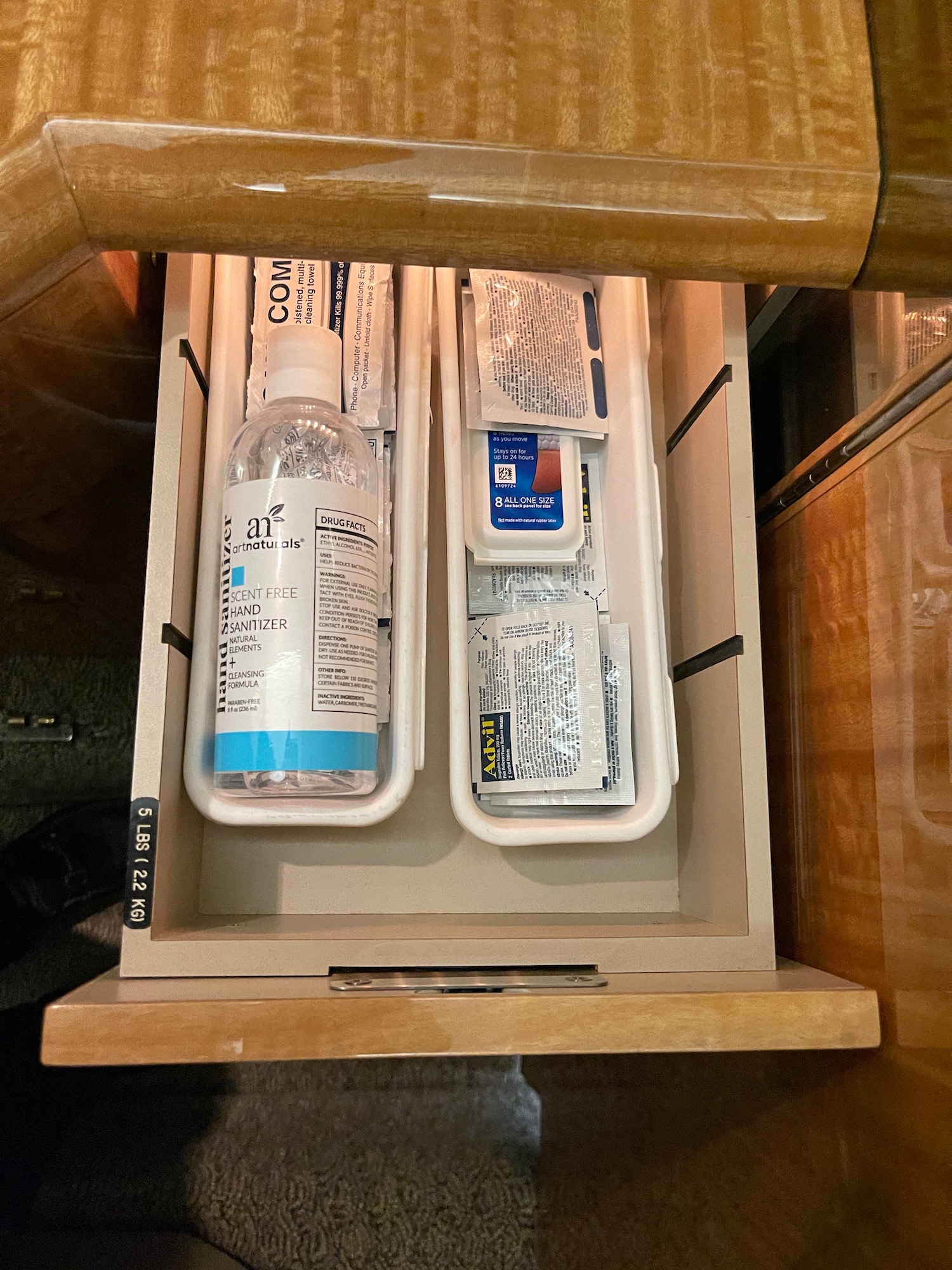 a drawer with a bottle and medicine in it