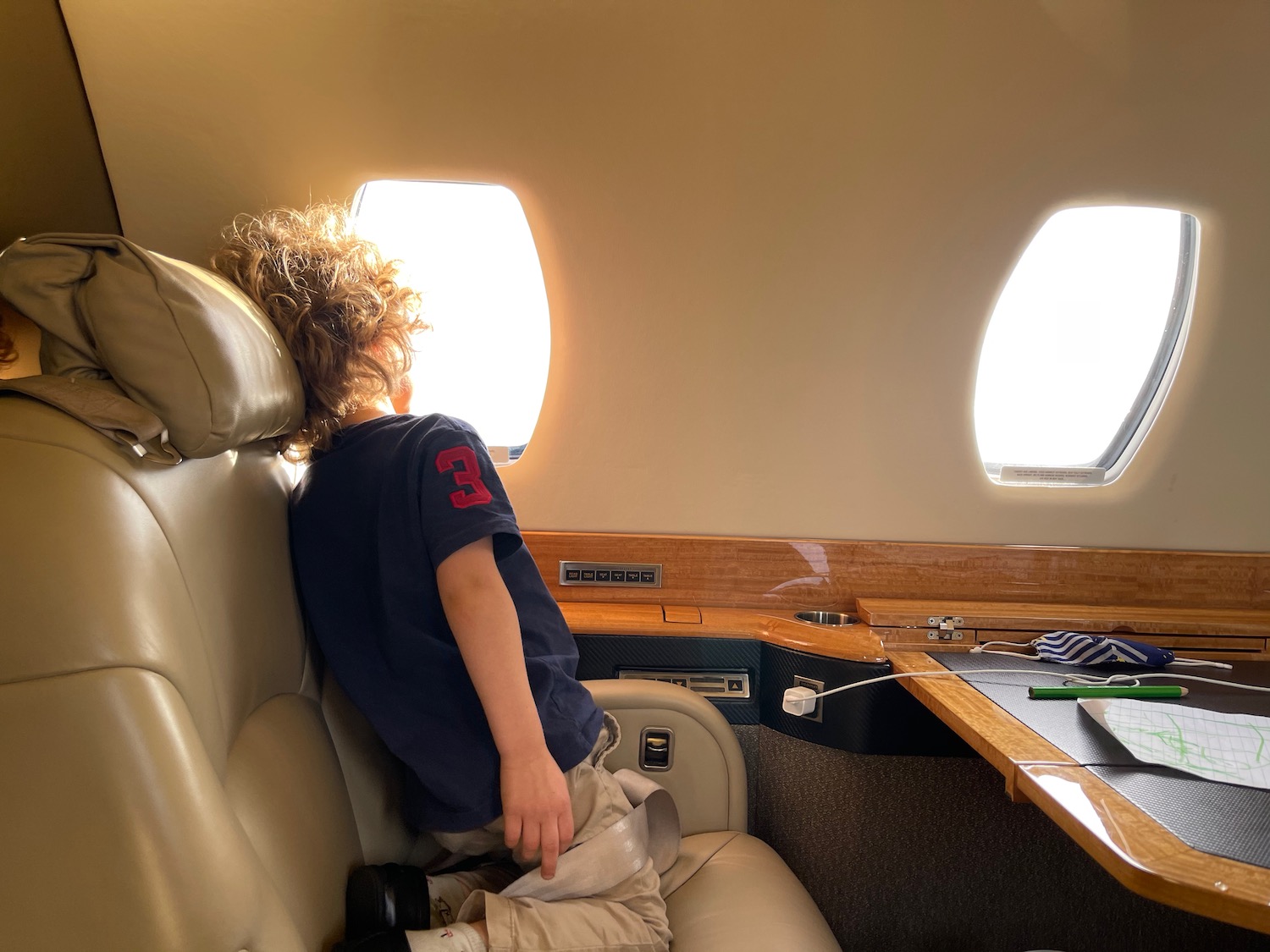 a child sitting in a chair in an airplane