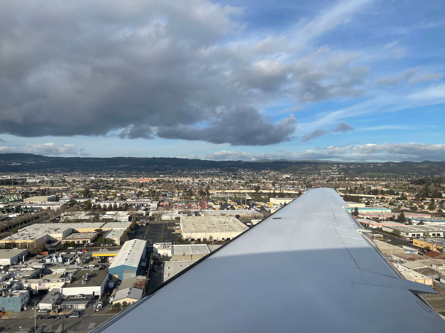 an airplane wing over a city