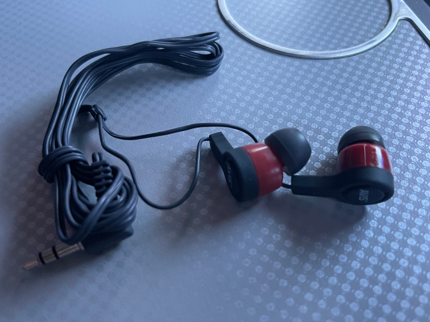 a pair of black and red earbuds