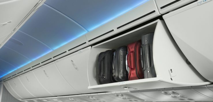 luggage in a shelf on an airplane