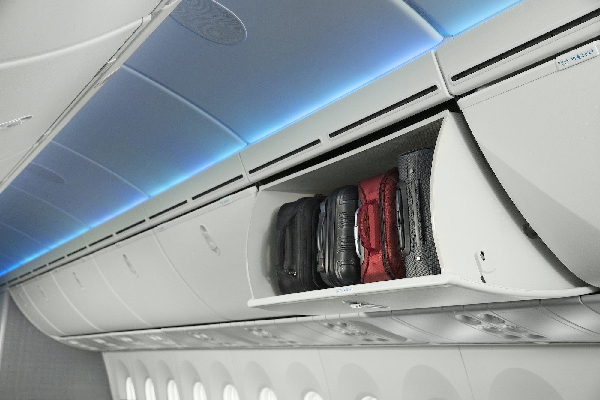 luggage in a shelf on an airplane