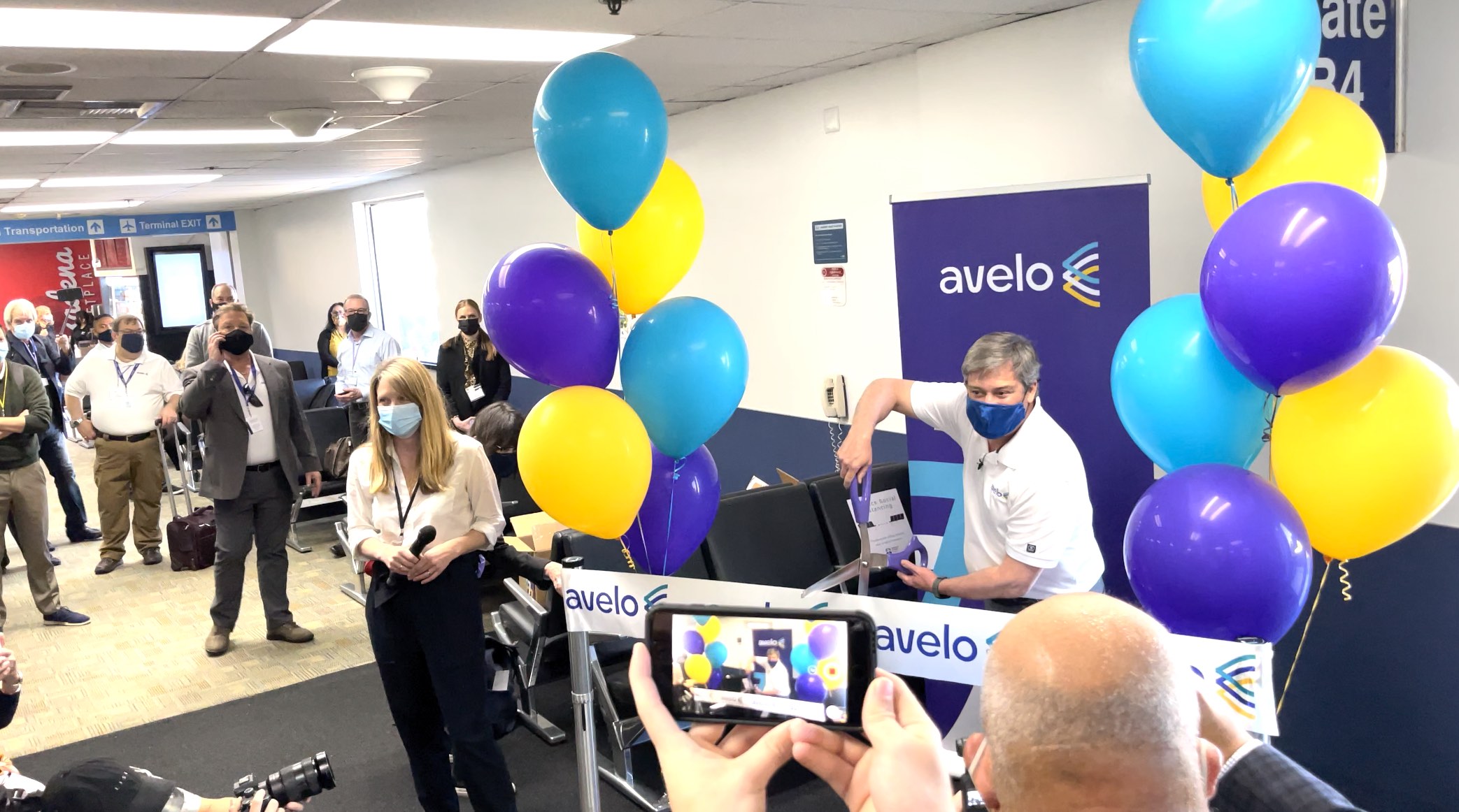 a group of people in a room with balloons