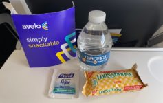 a bottle of water and candy bars on a table