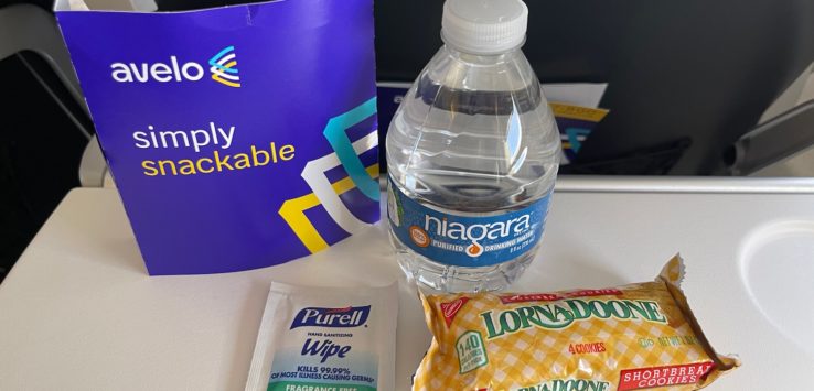 a bottle of water and candy bars on a table