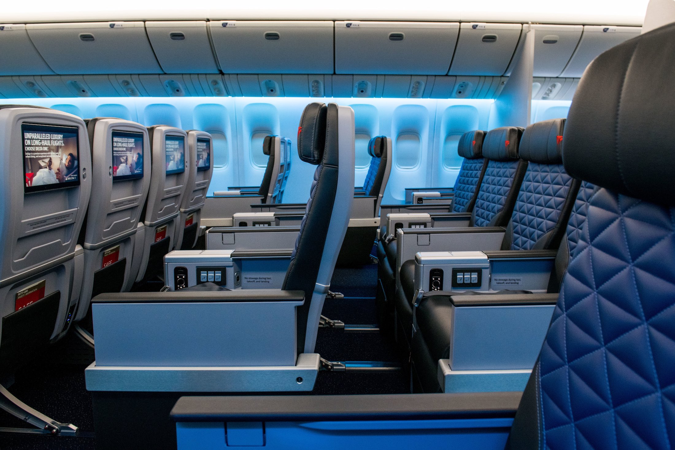 the inside of an airplane with seats and a tv