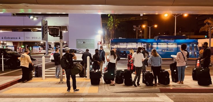 a group of people waiting at a train station