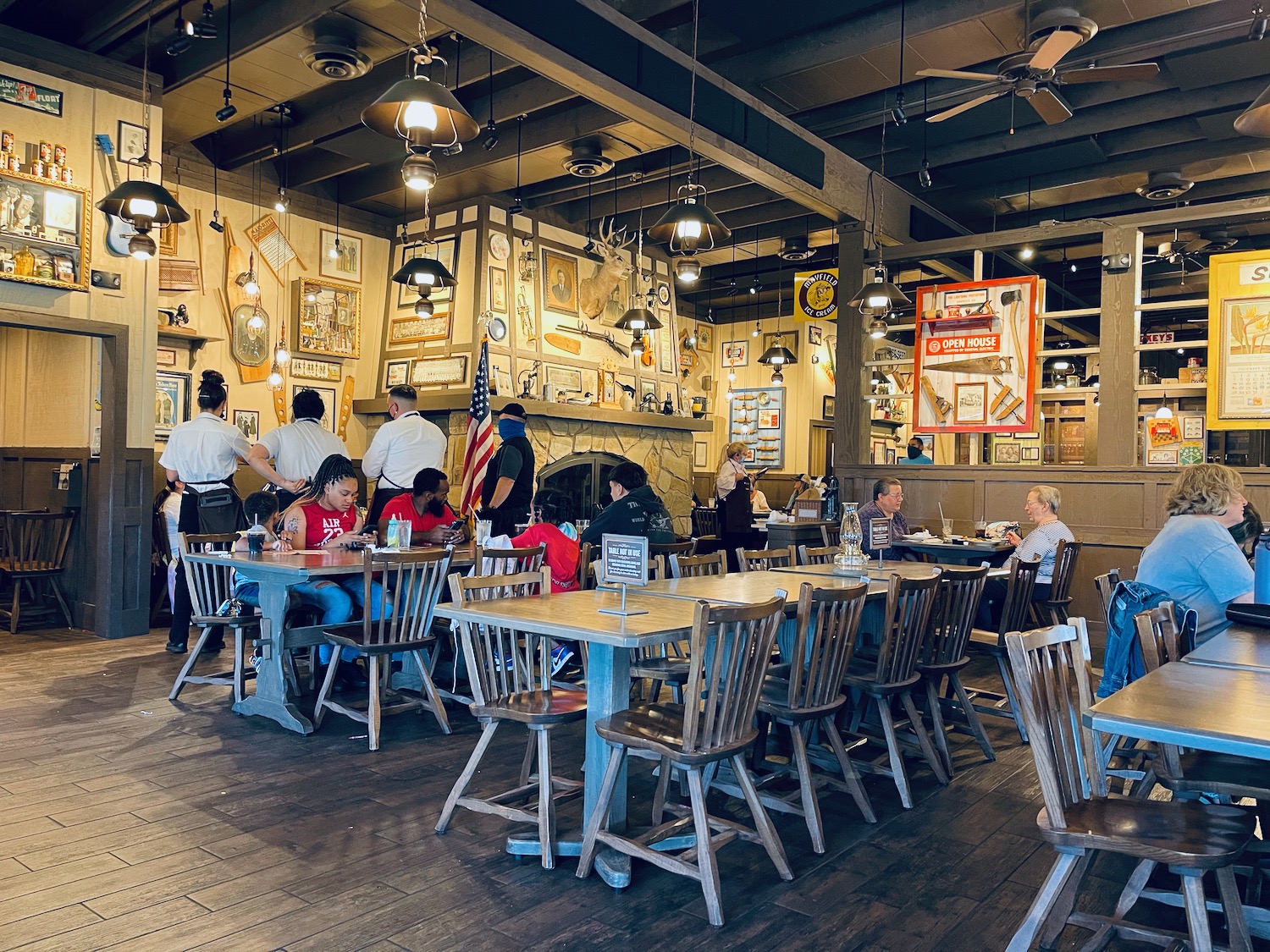 a group of people sitting at tables in a restaurant