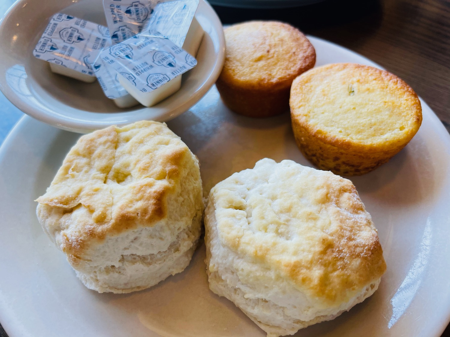 a plate of biscuits and muffins