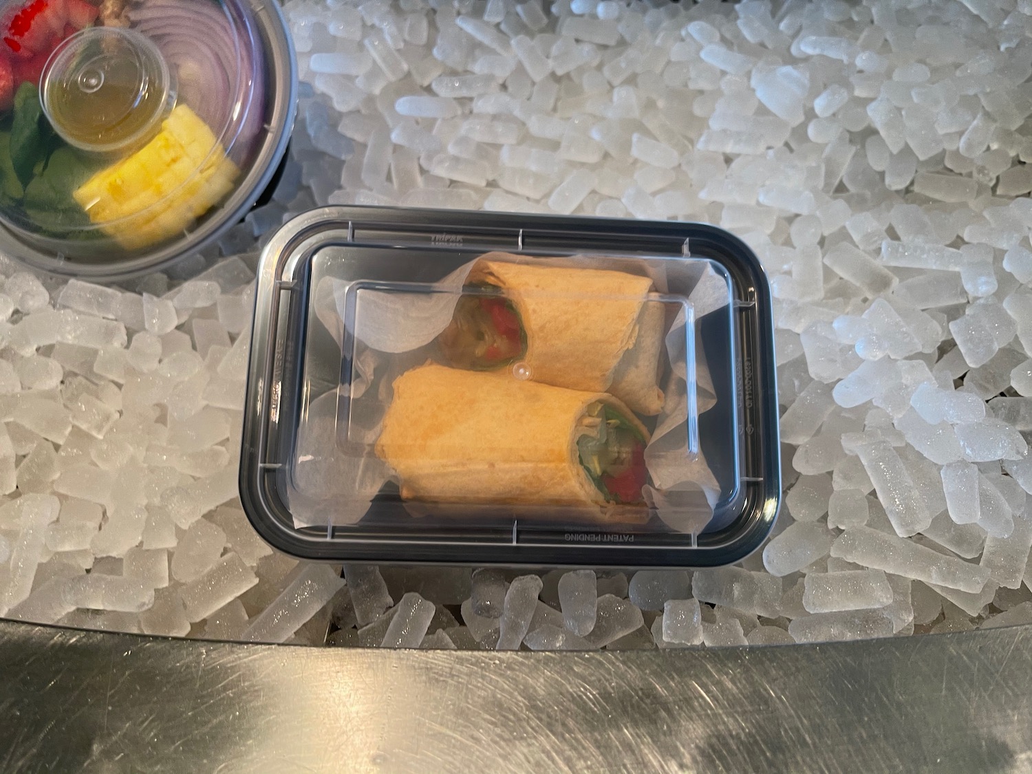 a food in a container on ice