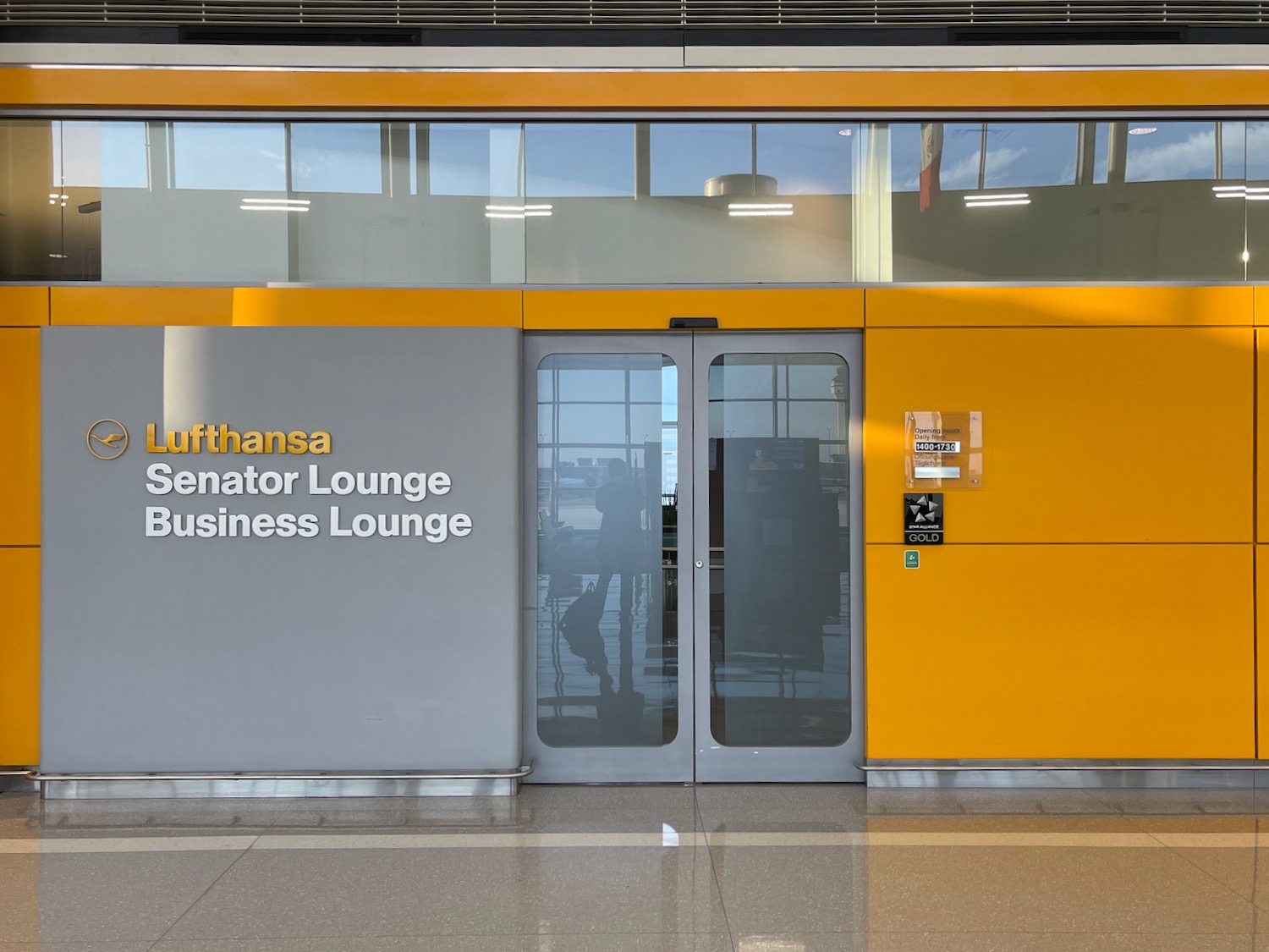 a yellow and grey building with glass doors