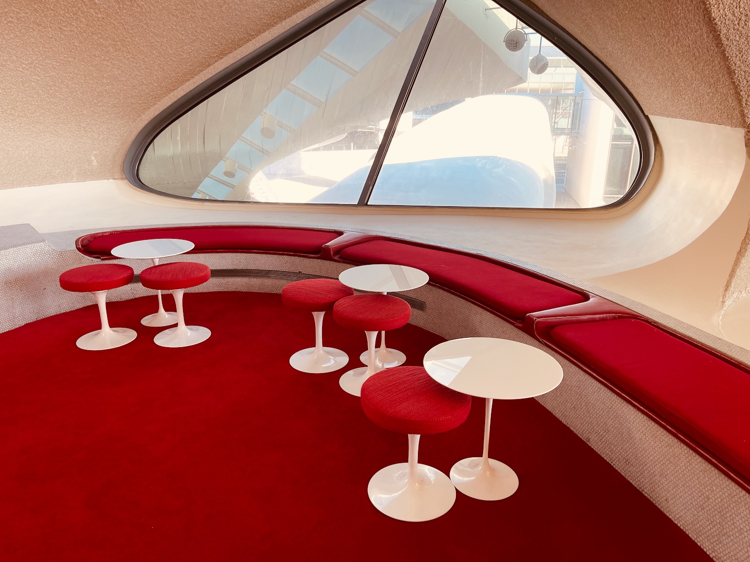 a round table and stools in a room