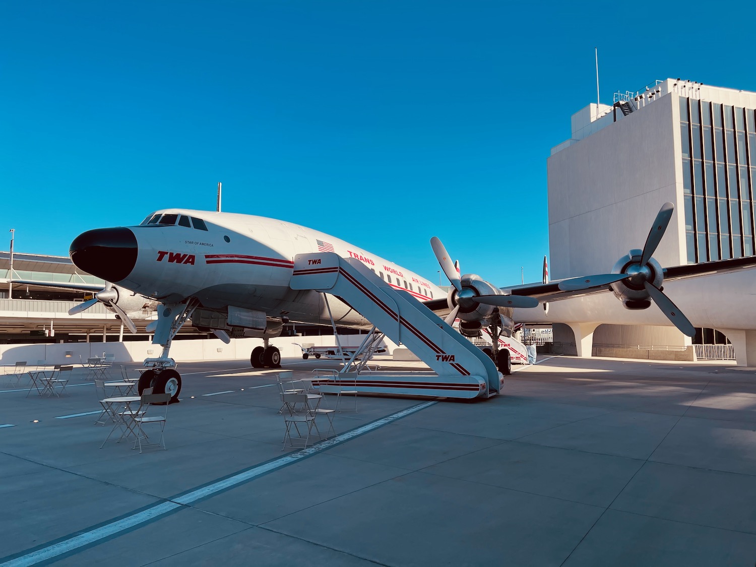 a plane with stairs and propellers