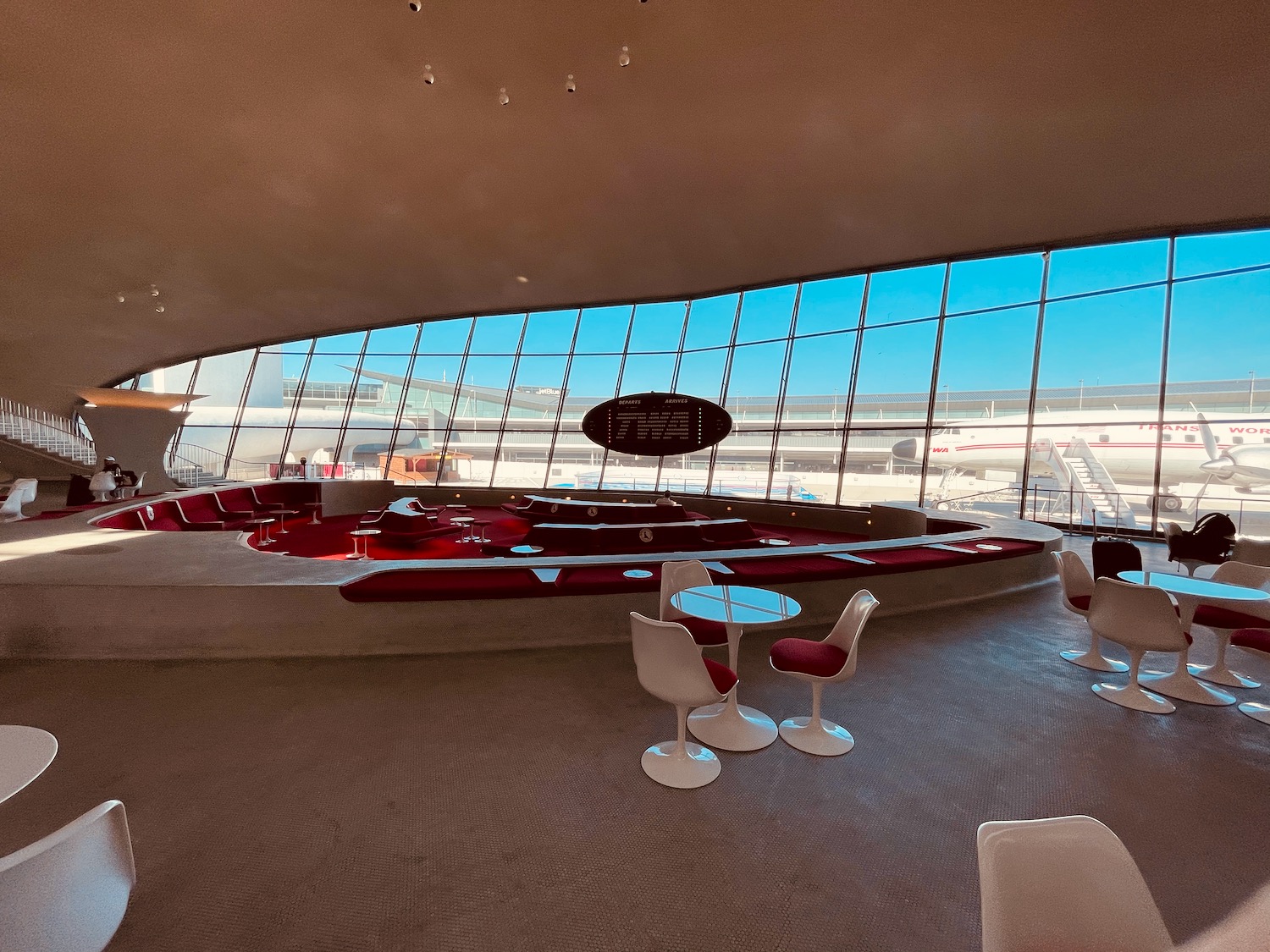 a large room with a round table and chairs