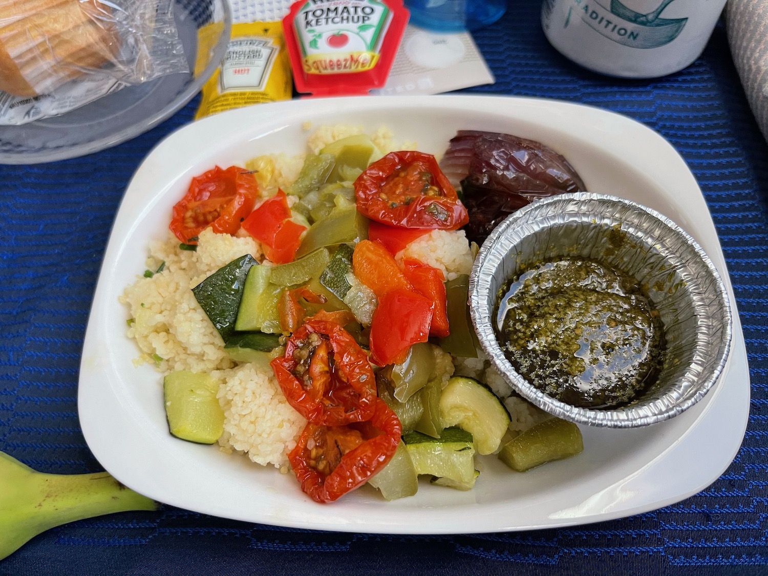 a plate of food with a small tin of sauce