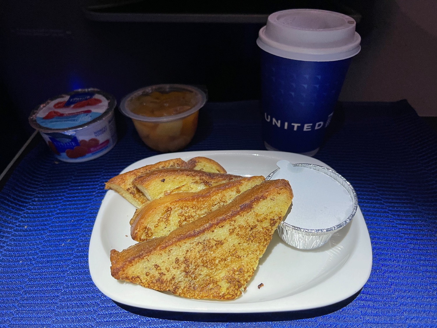 a plate of french toast and a cup of coffee
