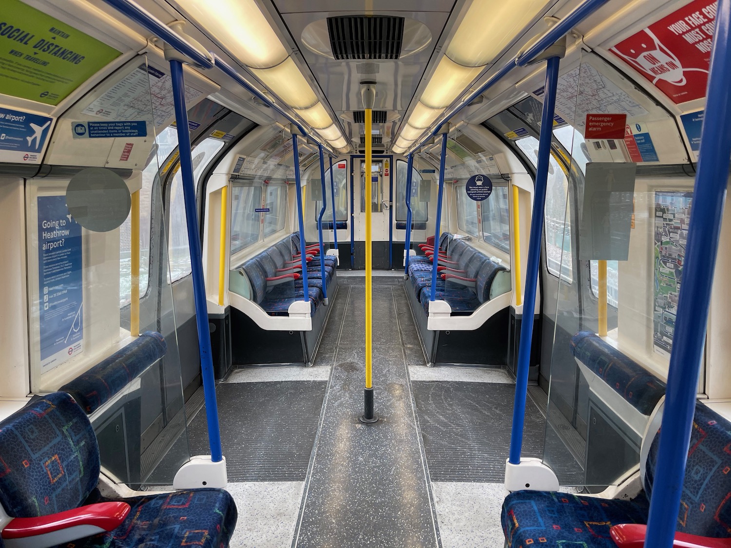 a train with blue seats and yellow pole