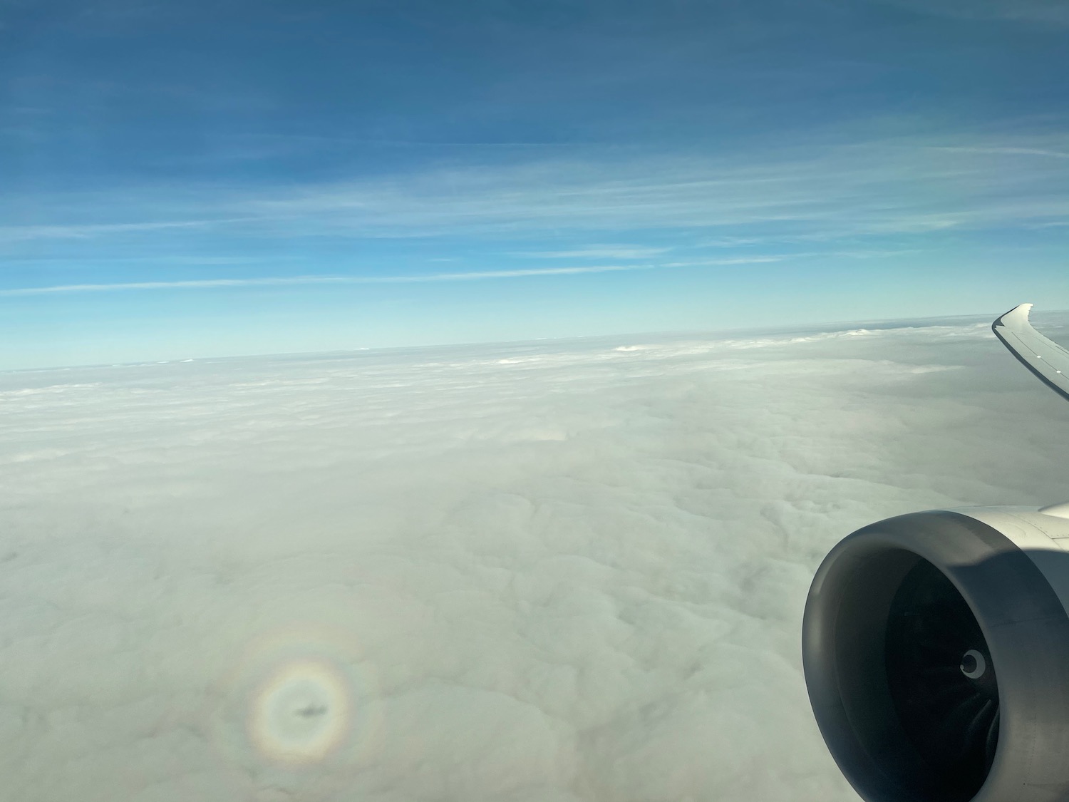 an airplane wing and a cloudy sky