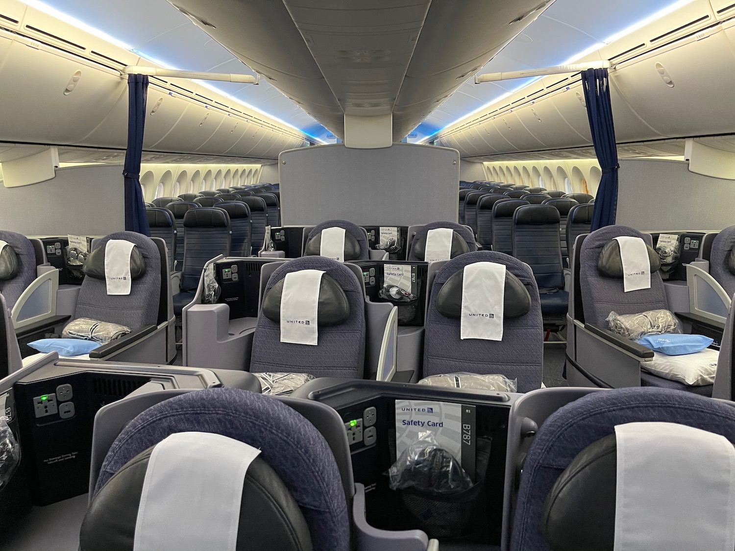 a plane with seats and a blue curtain