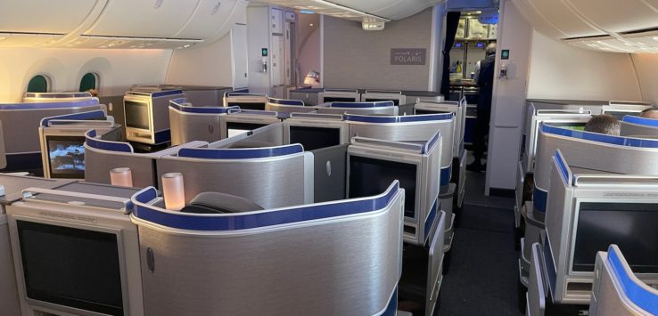 a plane with rows of seats and a tv
