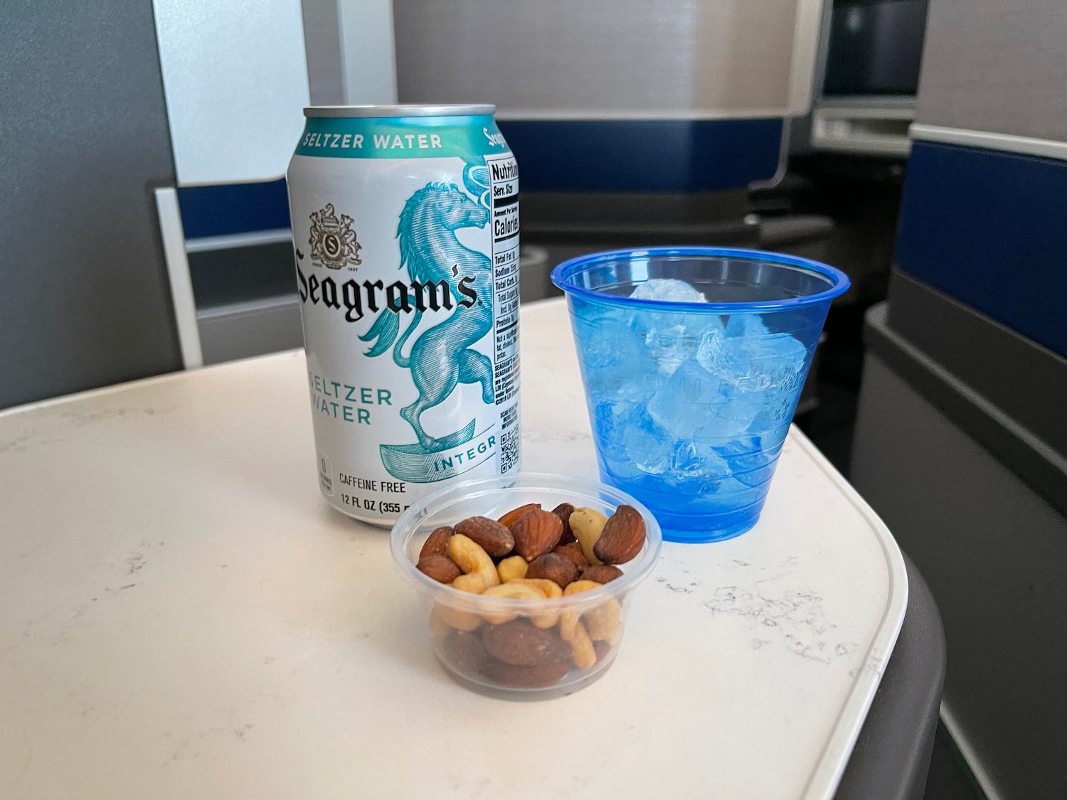 a can of water and nuts on a table
