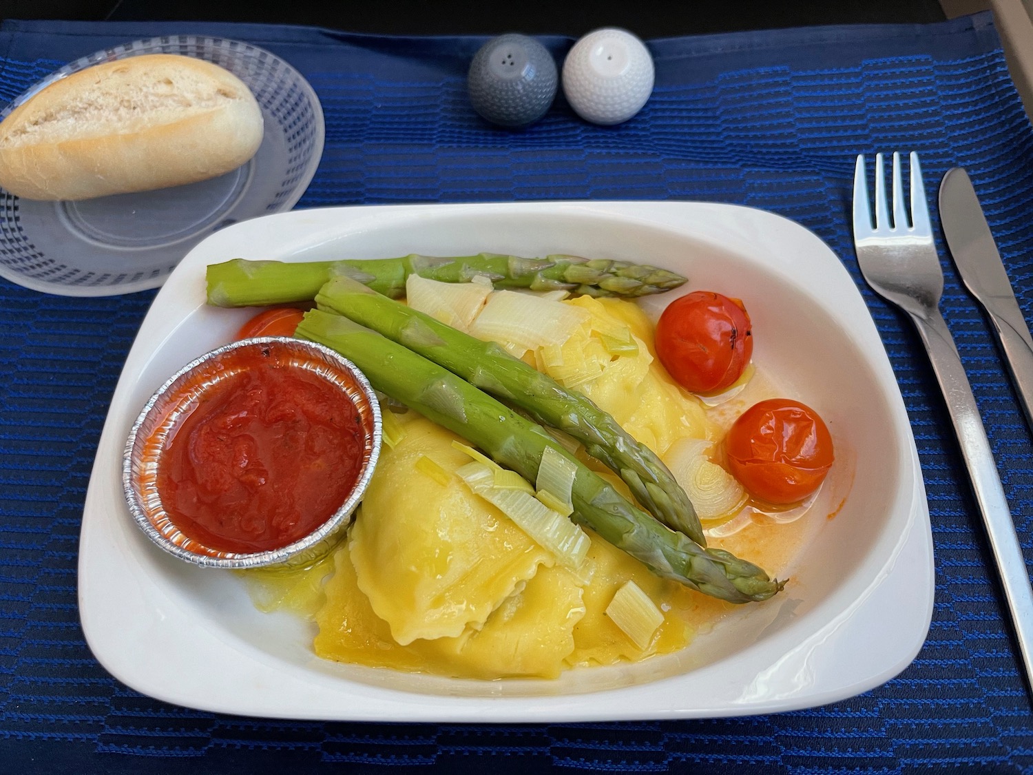 a plate of food with a fork and a plate of sauce