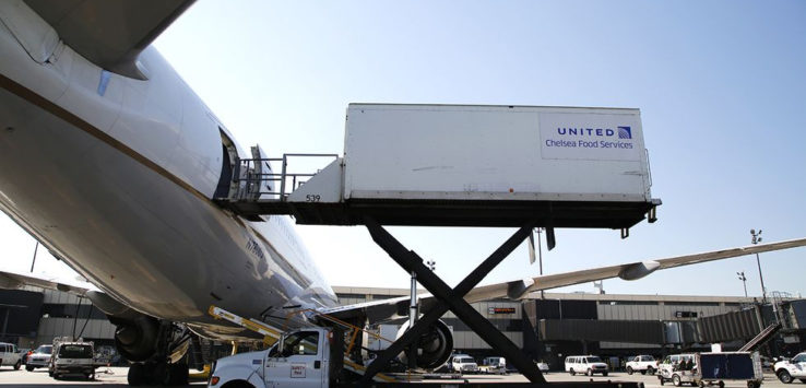 a truck loading a plane