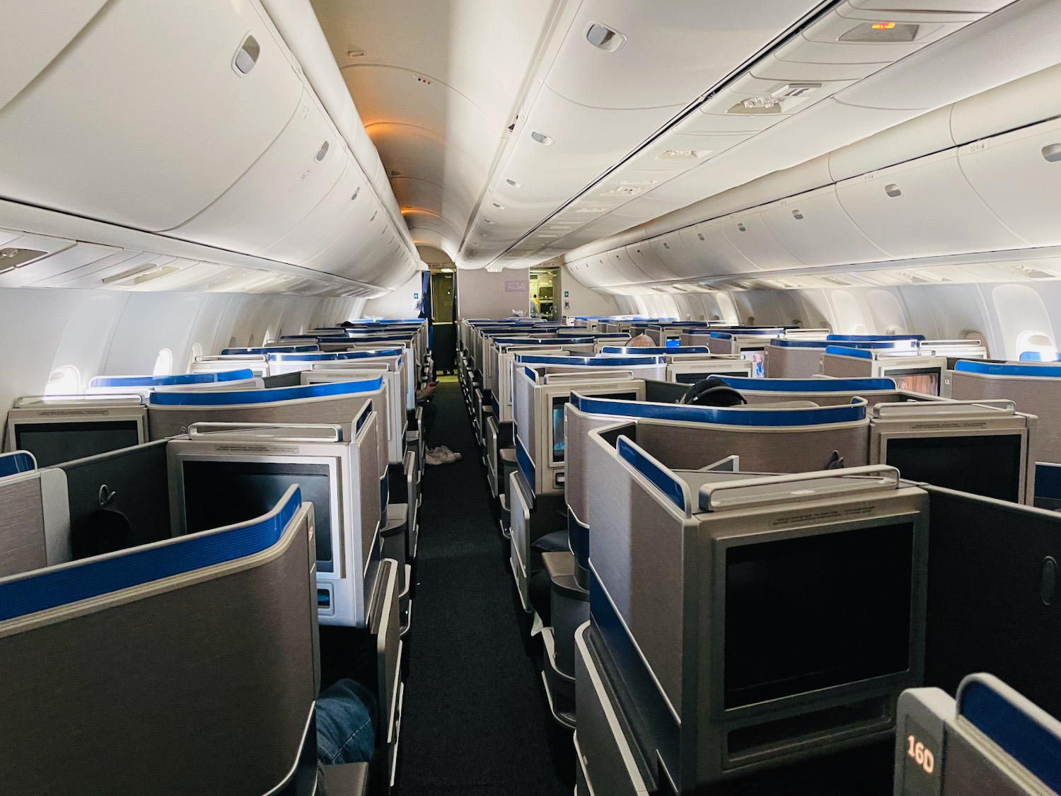 an airplane with rows of seats and monitors