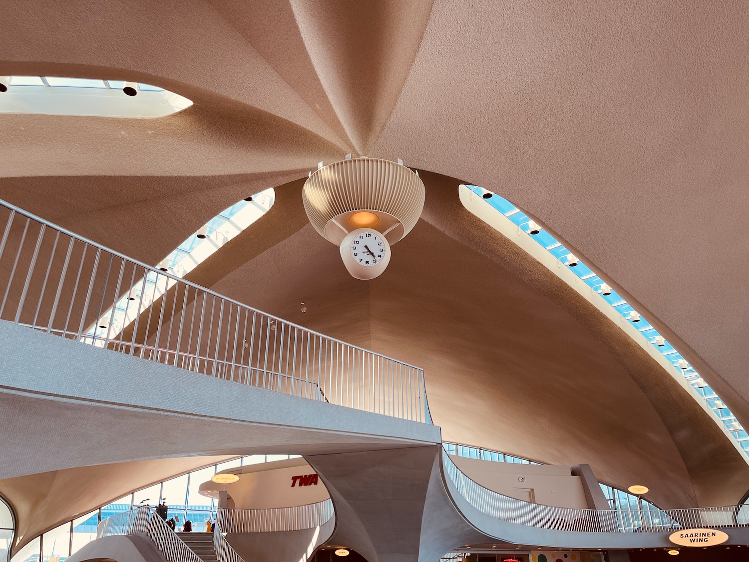 a clock from the ceiling of a building