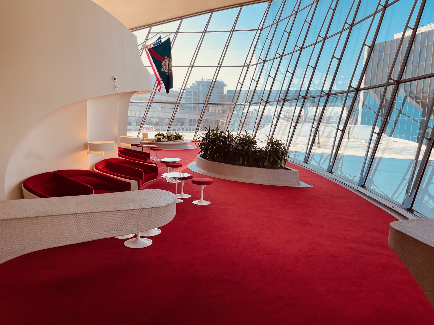 a red carpeted room with a large window