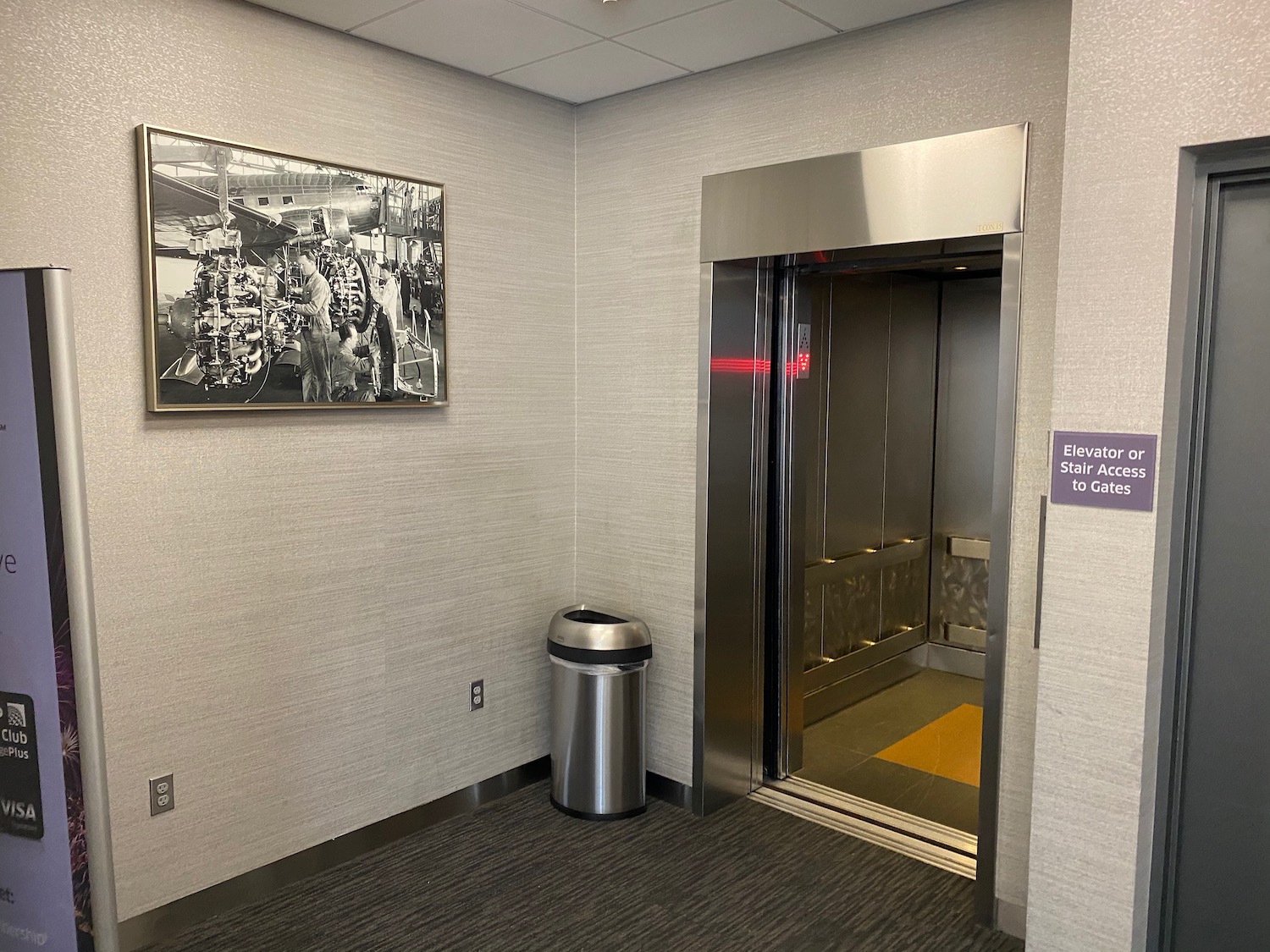 an elevator with a trash can in a room