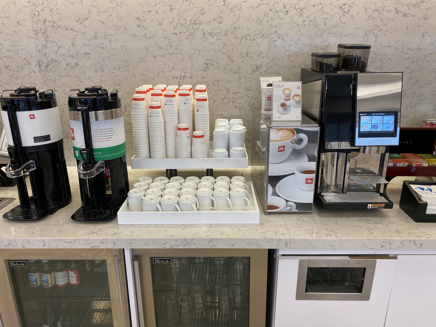 a coffee machine and cups on a counter