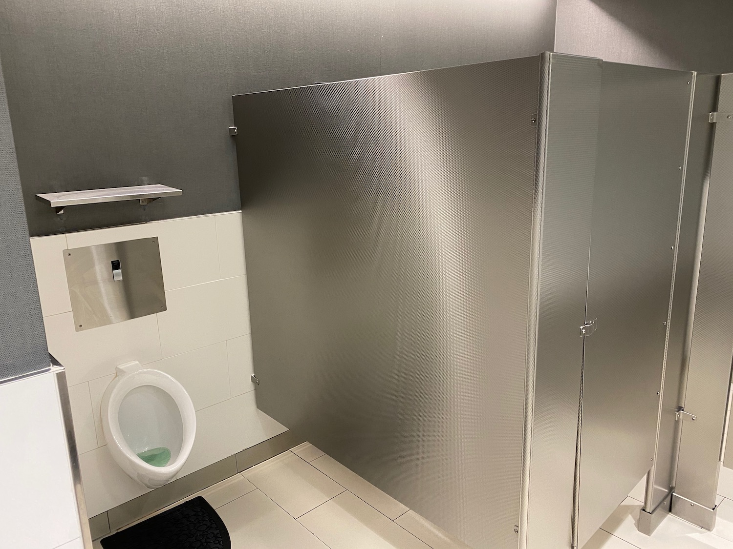 a bathroom with a silver stall