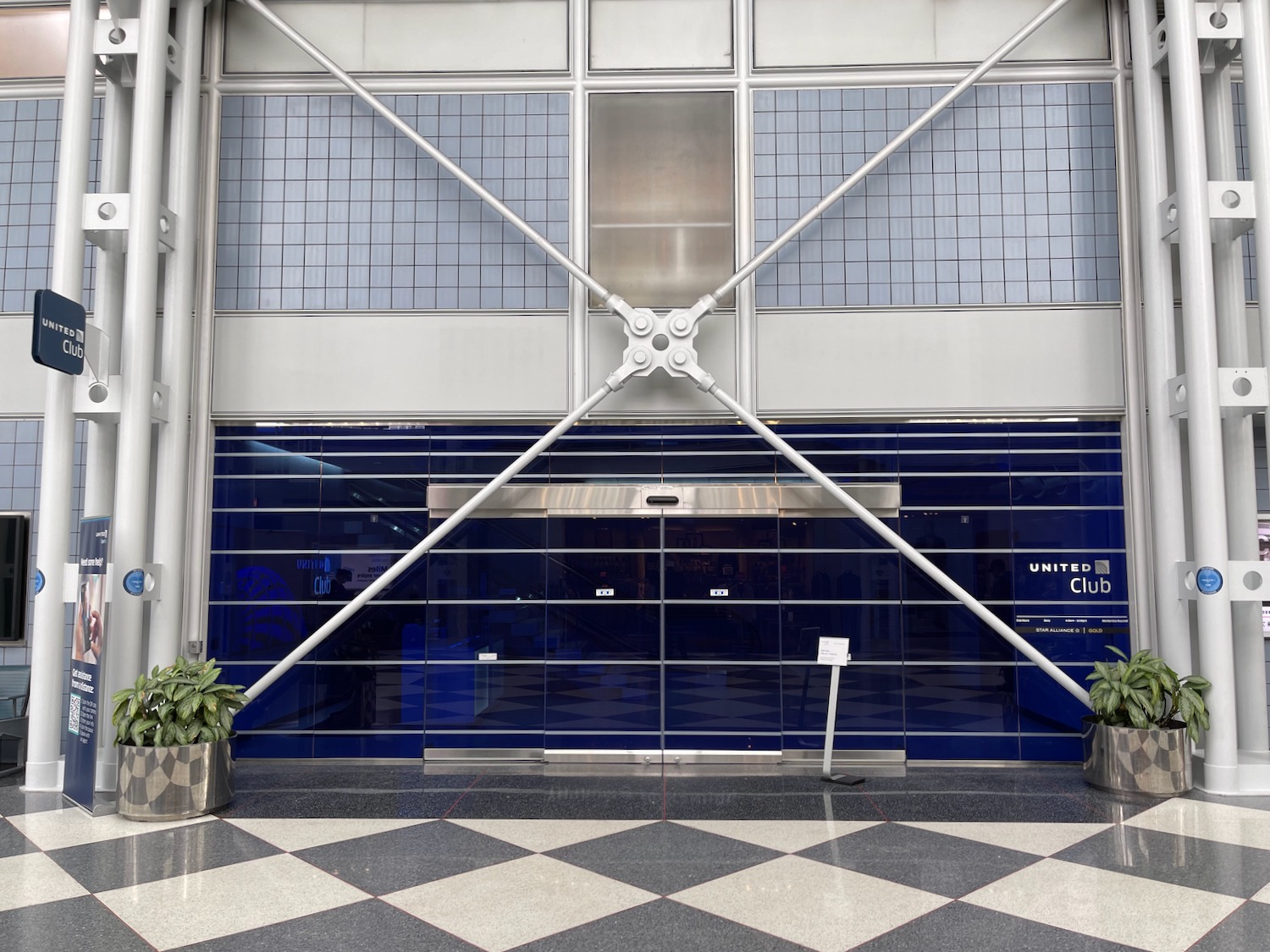 a large glass door with a cross on it