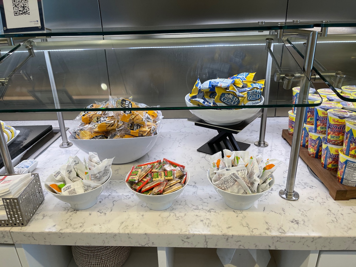 a glass display case with bowls of food