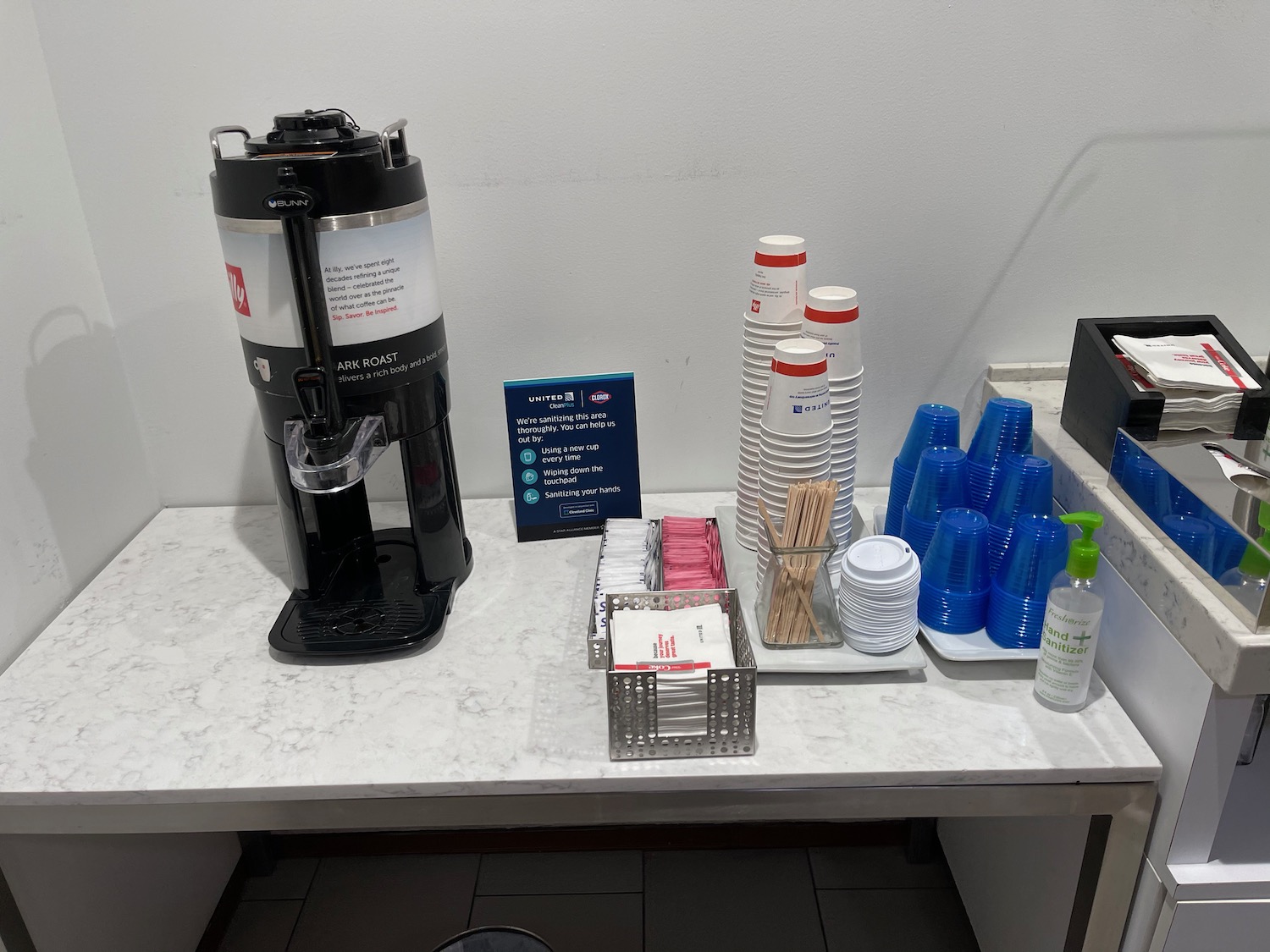 a coffee machine and cups on a table