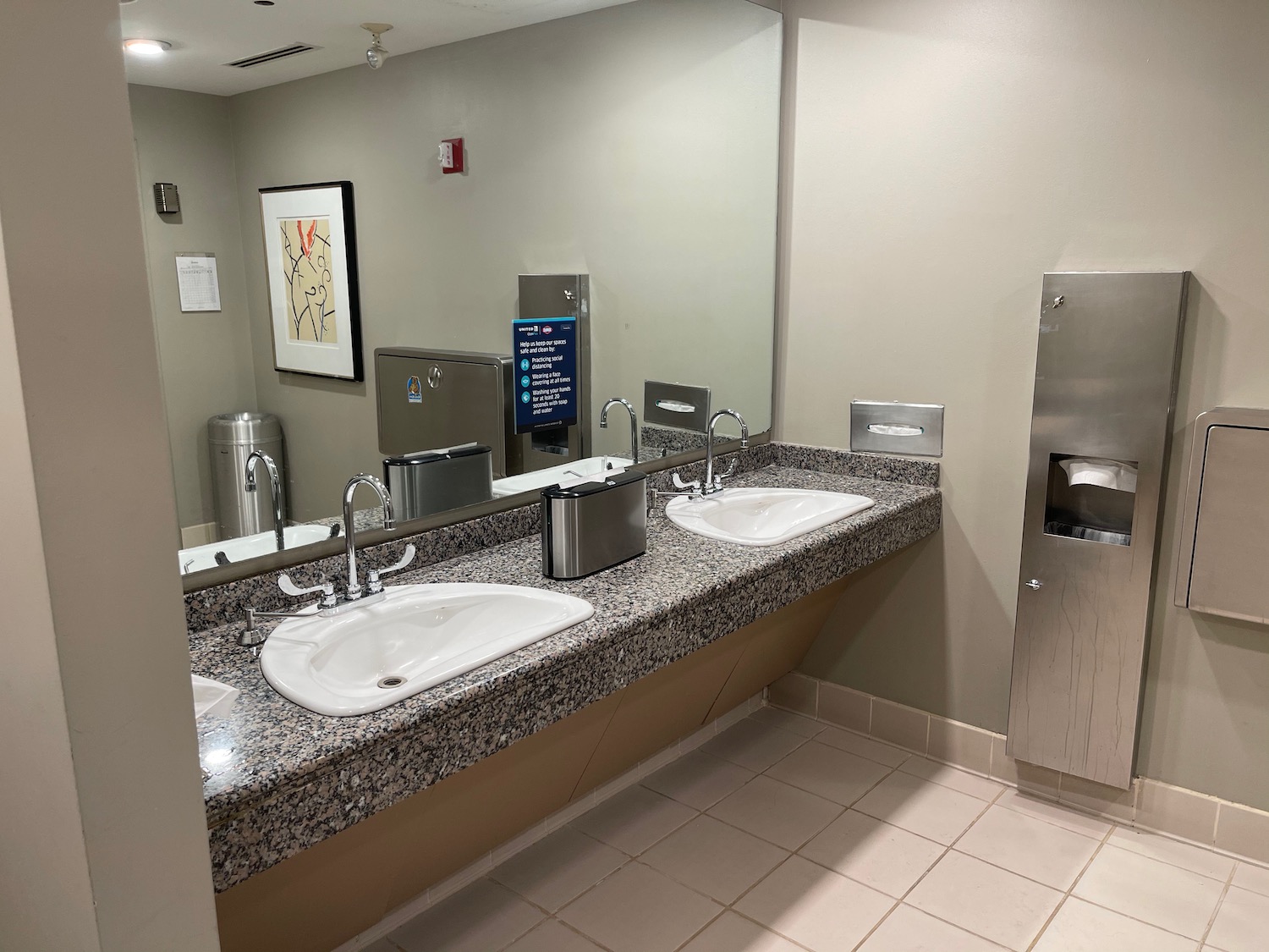 a bathroom with sinks and a mirror